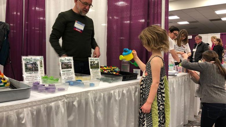 Mark Boudreau teaches a child about the environment. 